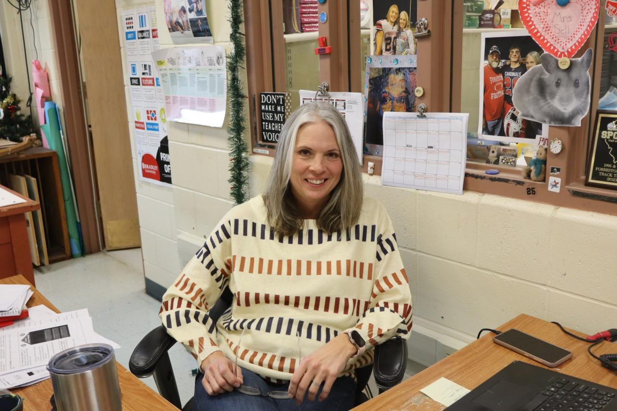 Danelle Setterstrom poses for a photo at her desk